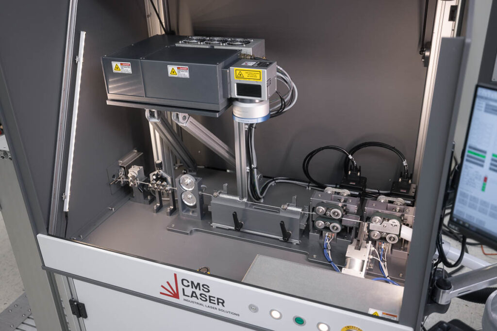 Top down angled view of a UV laser marking machine for aerospace wires
