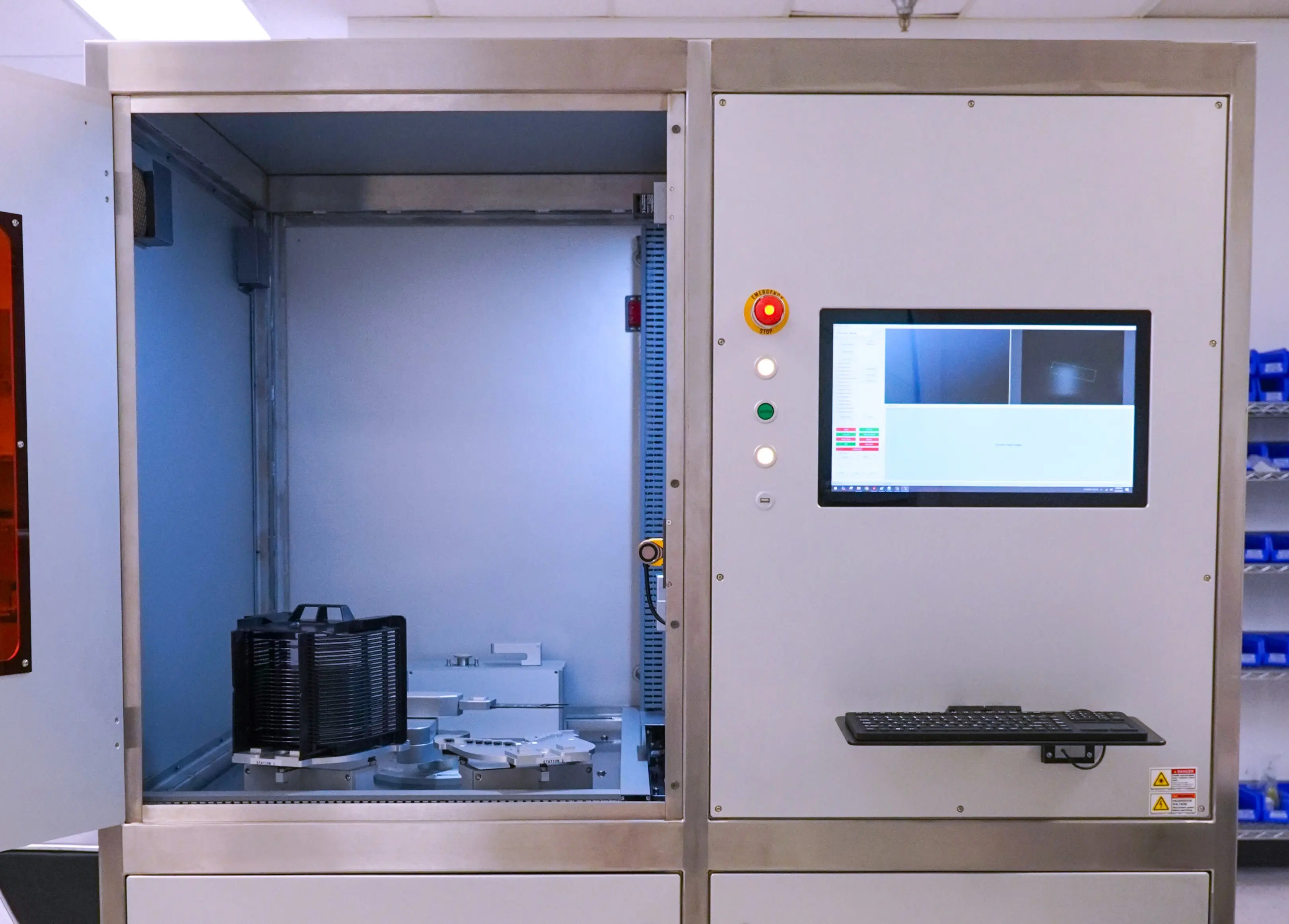 Advanced CMS laser manufacturing machine with a control screen and wafer processing equipment.